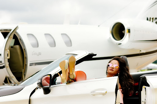 woman in a luxury car and jet airplane